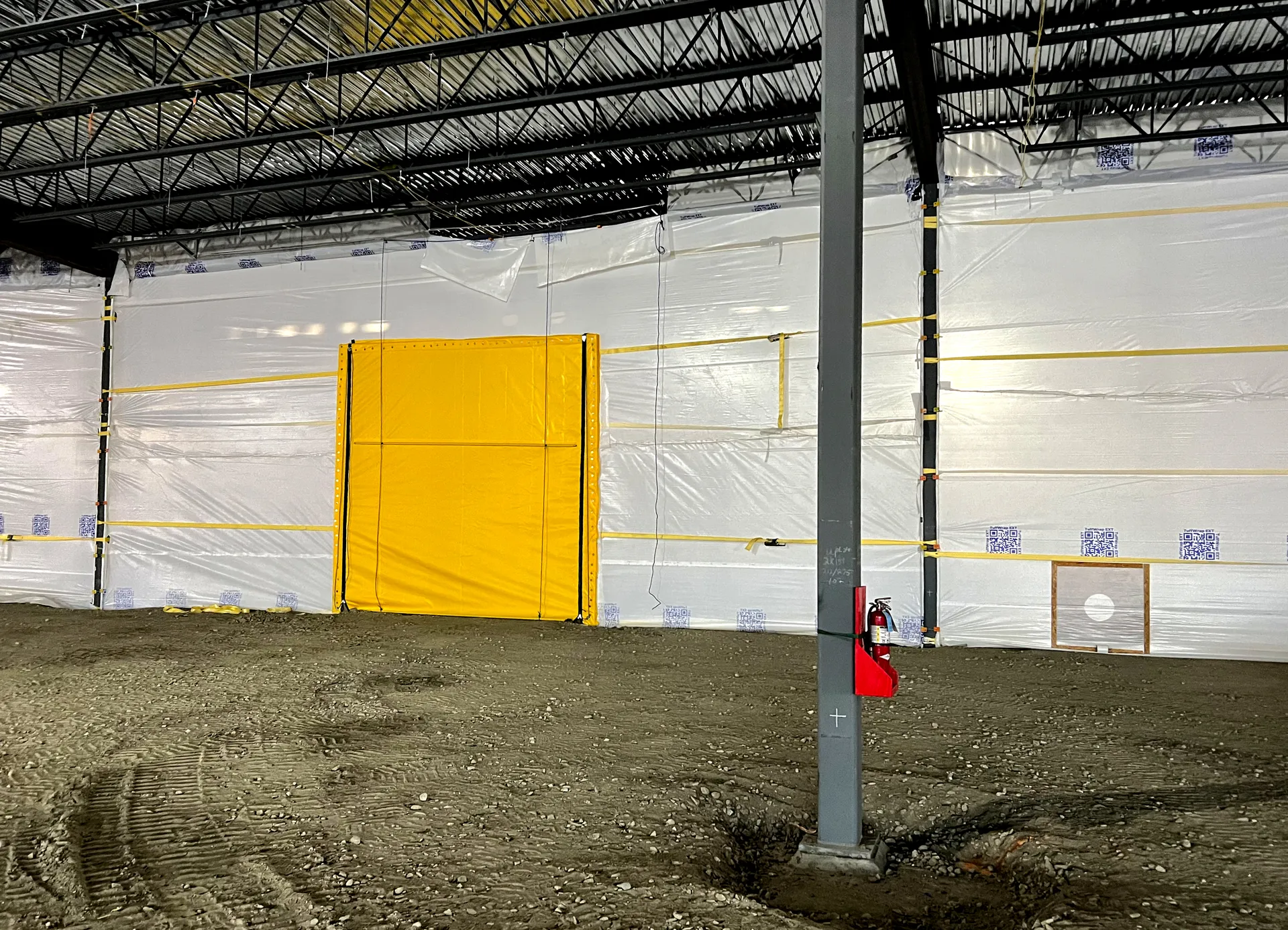 A TuffWrap EXT Wall with a big yellow EXT Door in the middle with a vent off to the side